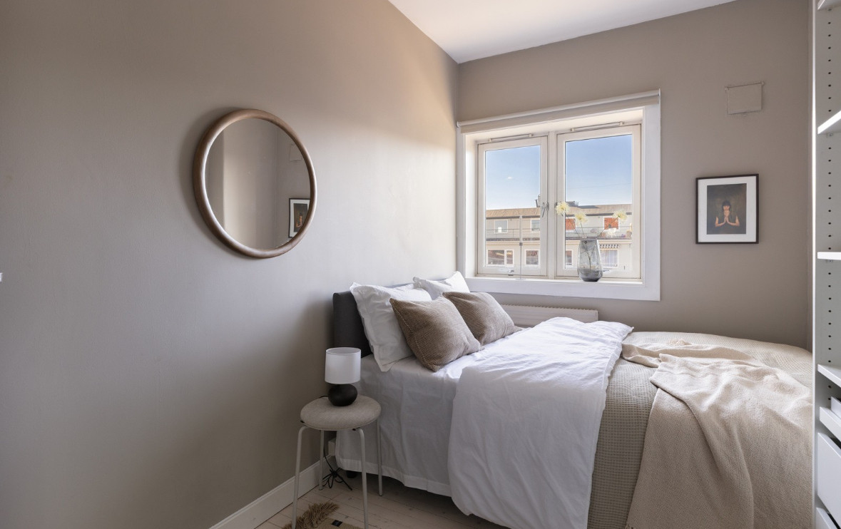 Rommet har plass til dobbeltseng, skrivepult og garderobeløsning. Det er også meget hyggelig utsikt mor borettslagets fellesarealer fra soveromsvinduet.