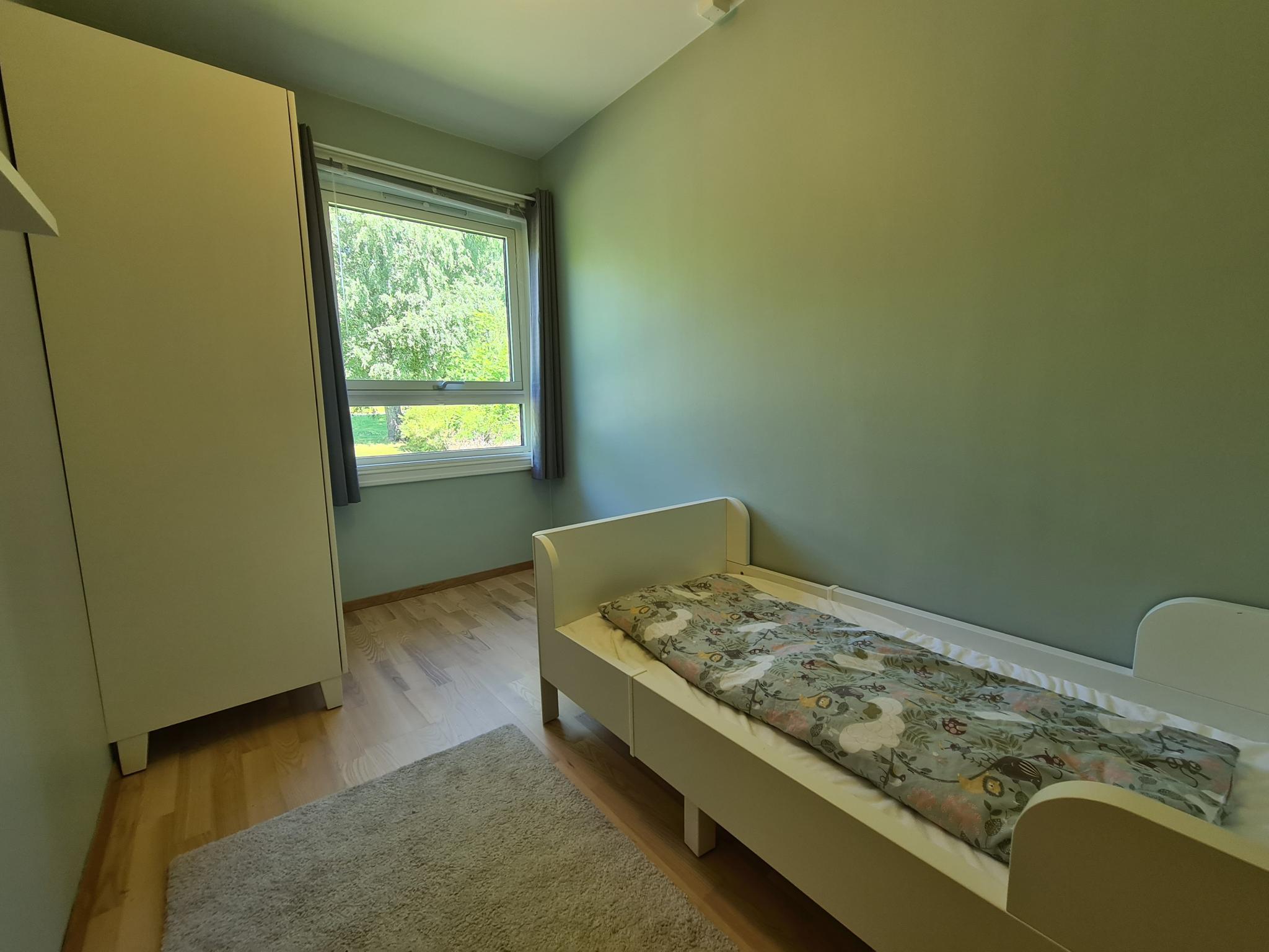 Minste soverom med plass til seng skap og kontorplass.  Vegger malt i mintgrønn.
