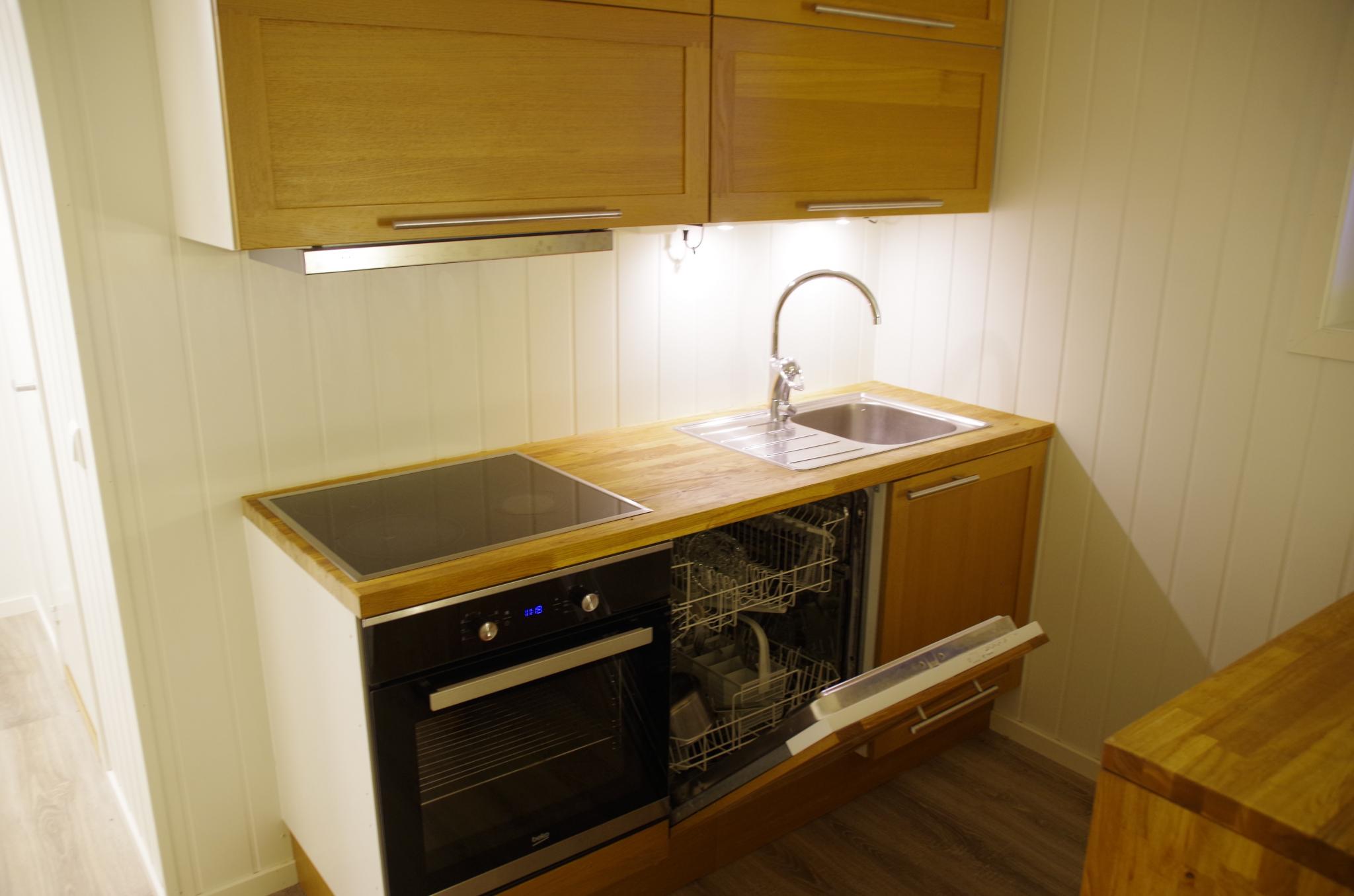 Kjøkken med komfyr og oppvaskmaskin