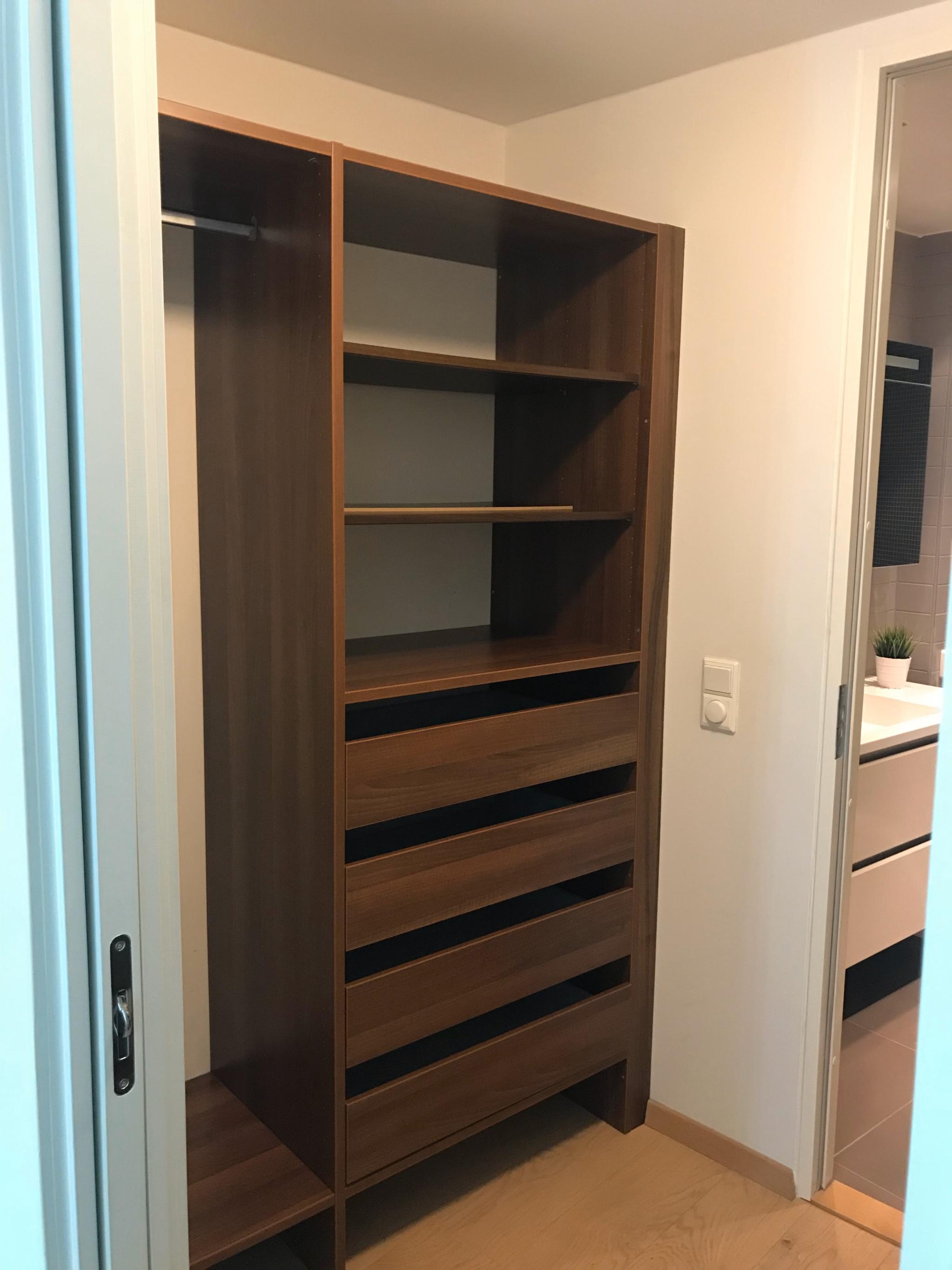 Walk in closet connecting the main bedroom to the bathroom. 