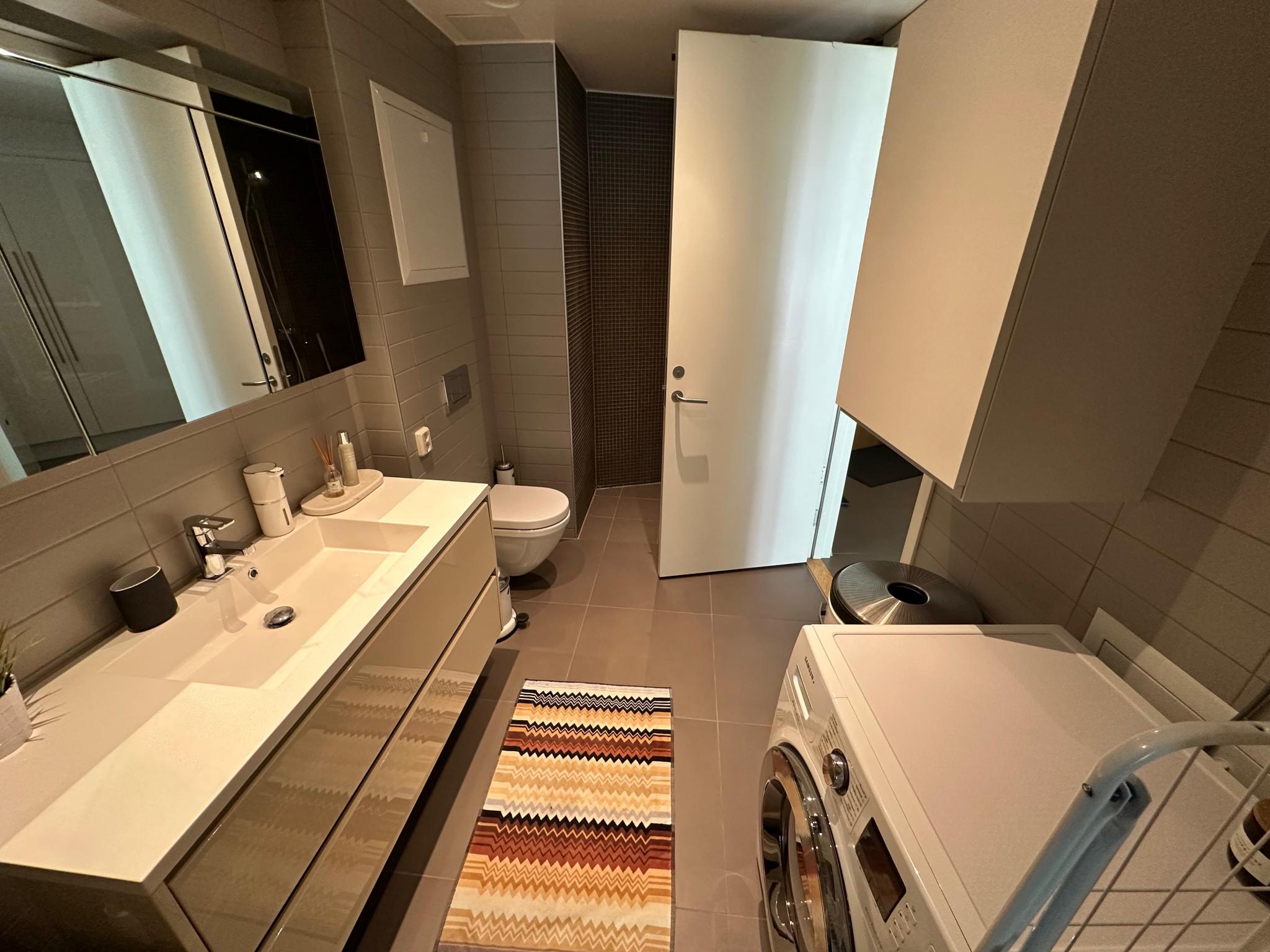 Bathroom with spacious shower (behind the door) and floor heating. 