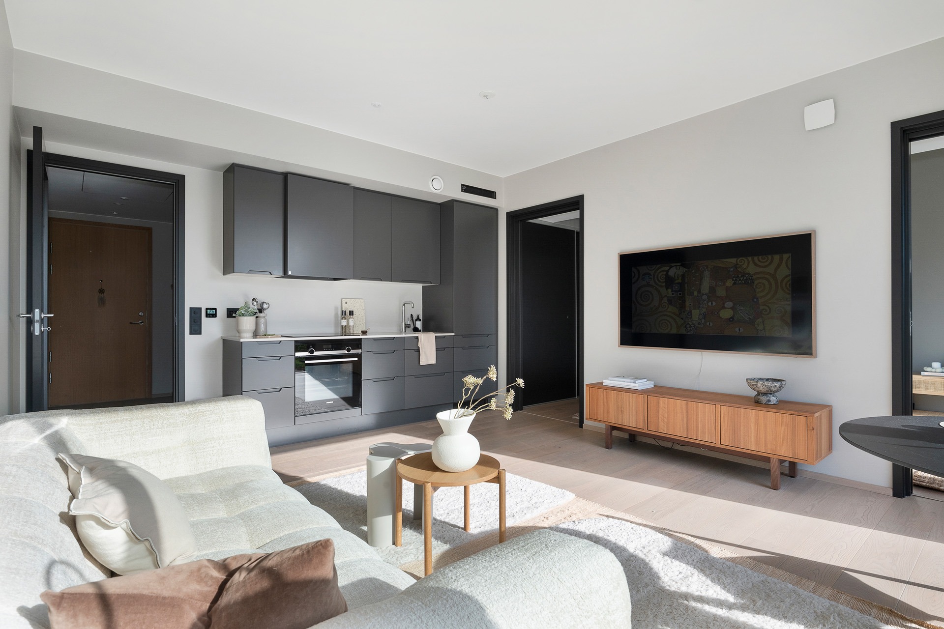 Gjennomført standard fra 2021 med god takhøyde og lekker 1-stavs parkett over vannbåren gulvvarme. Stilrent kjøkken fra HTH med slette fronter i koksgrå utførelse og benkeplate i stein.