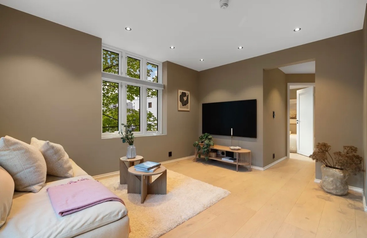 Stue med sofa 65’’ TV og spisegruppe