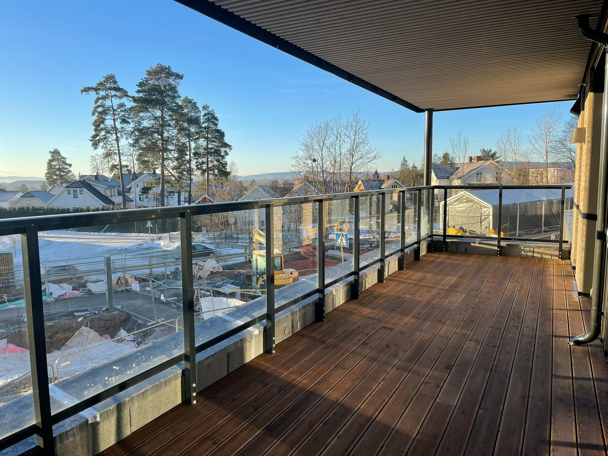 En romslig overbygget terrasse på 19 kvm går langs hele leiligheten.  Her er det sol fra morgen til kveld samtidig som overbygget skjermer  leiligheten for solsteken