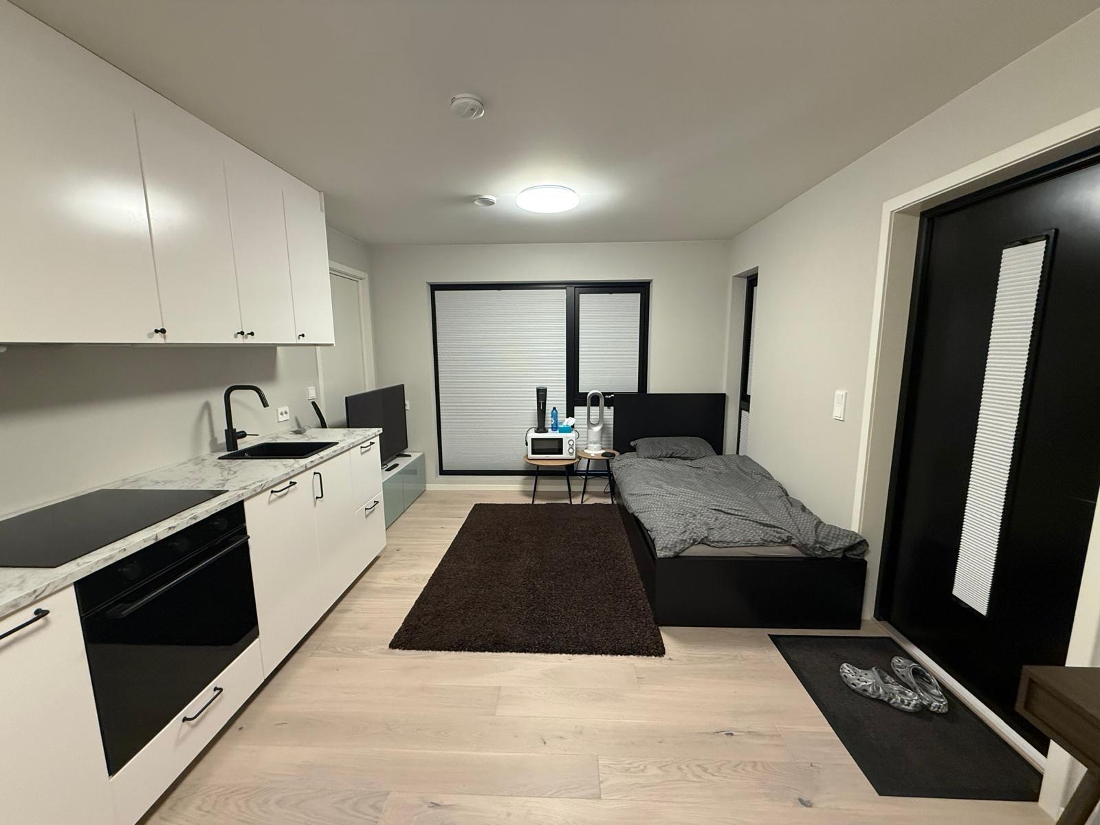 Living area with a bed on the other side.