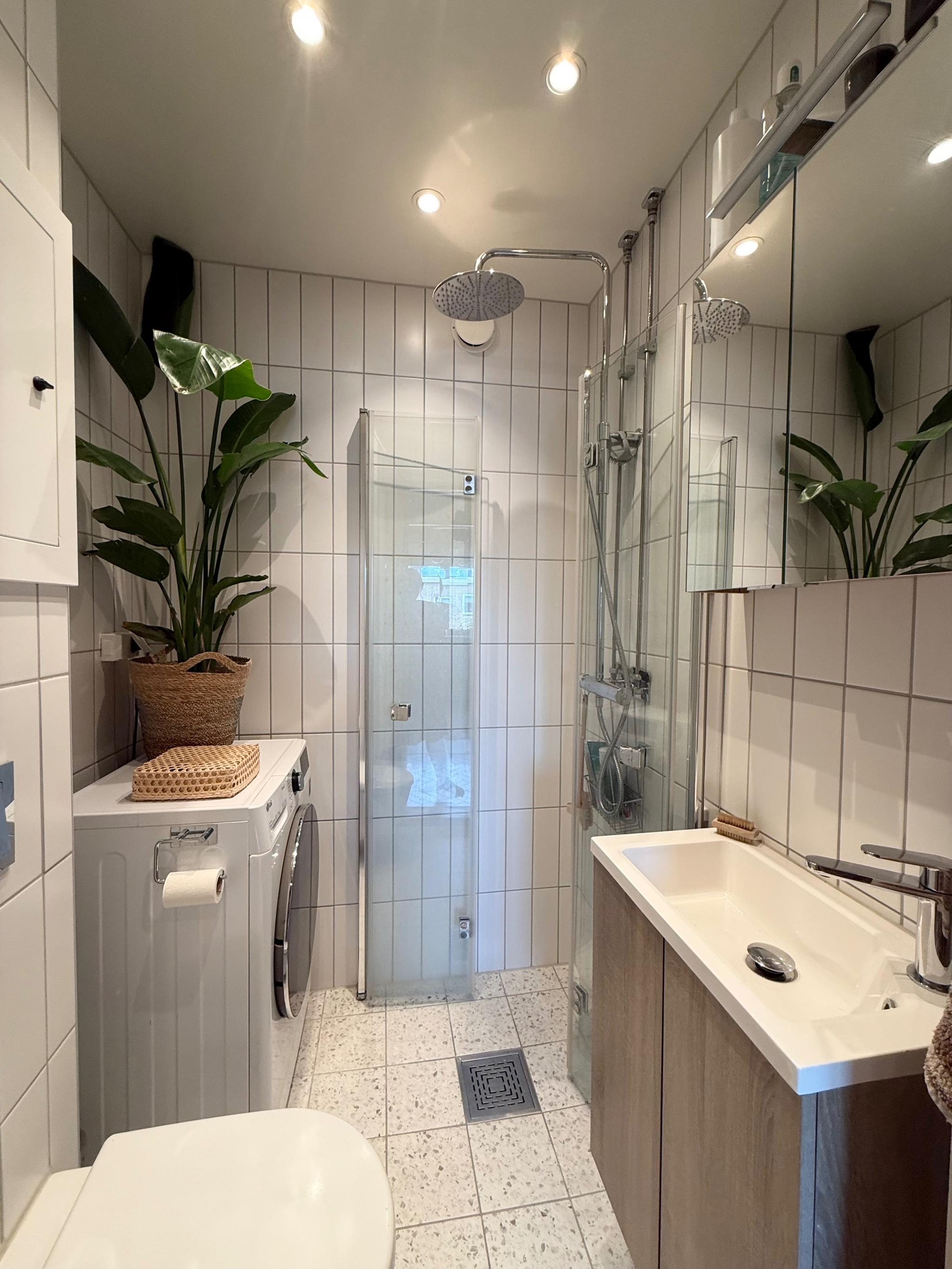 Bad med varmekabler i gulv, downlights, vaskemaskin og takdusj