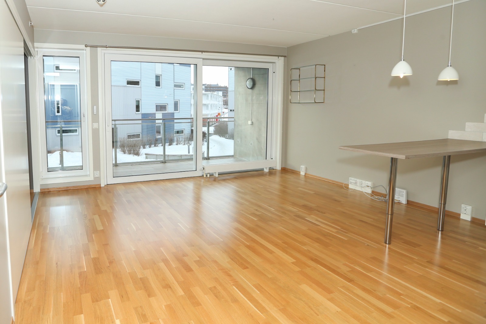 Lys stue med store vindusflater og utgang til vestvendt balkong