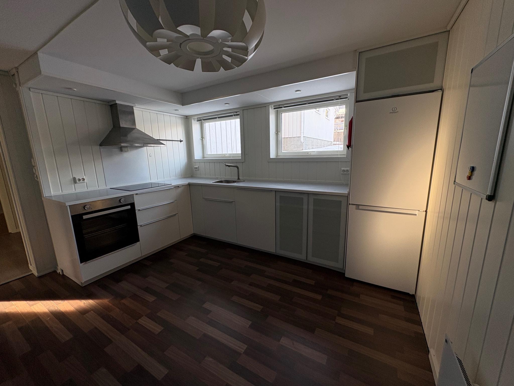 Kjøkken med kjøl/frysskap, oppvaskmaskin, stekeovn og induksjonsplatetopp