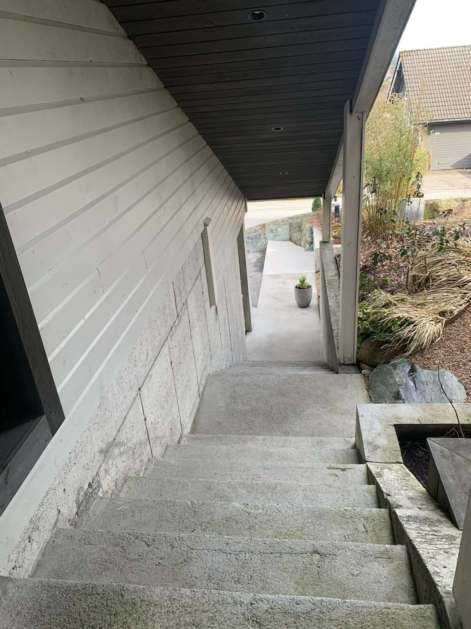 Utendørs trappeoppgang langs garasje.