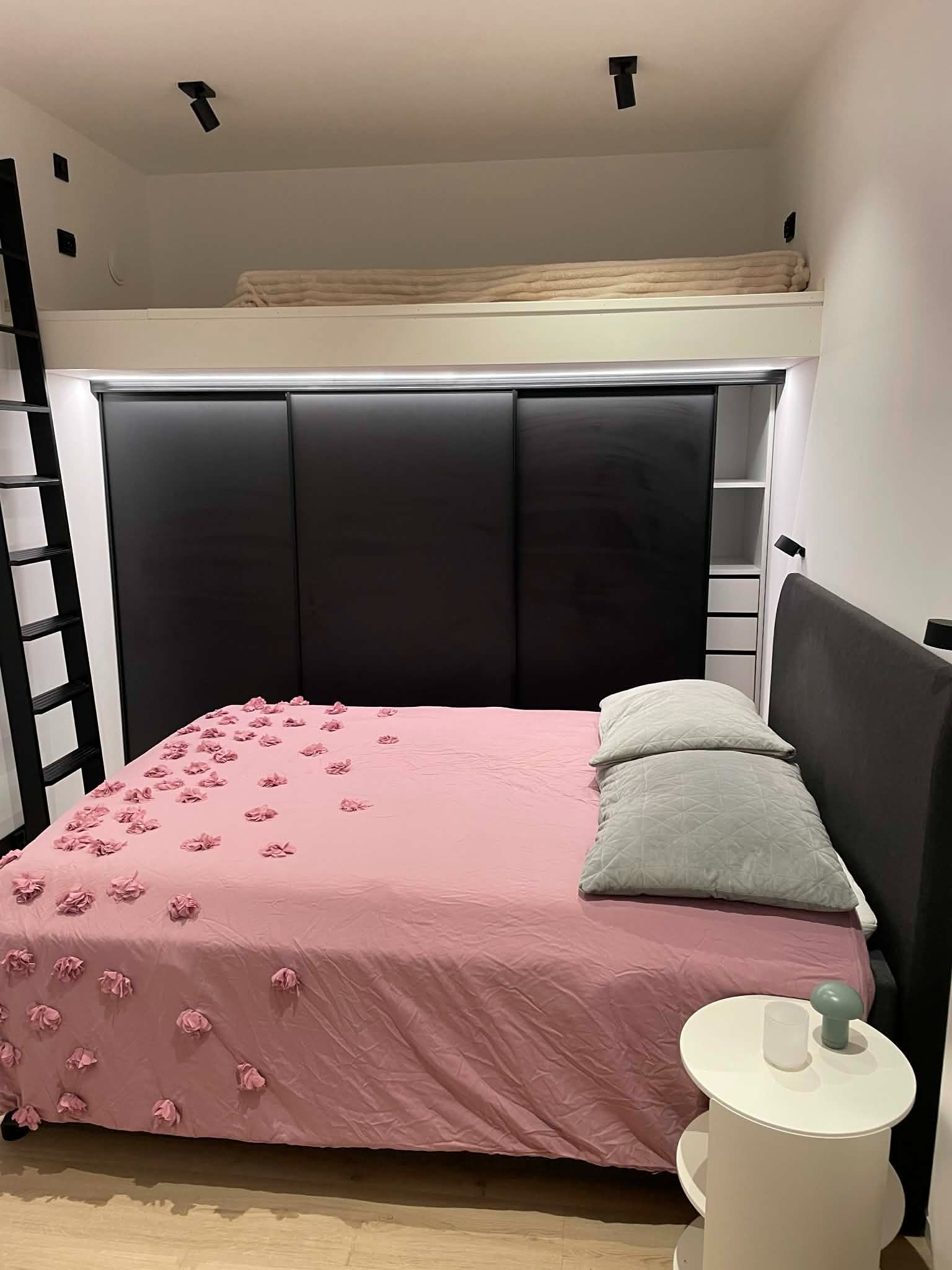 Soverom med stor skyvedørsgarderobe samt dobbeltseng med oppbevaring og hems.