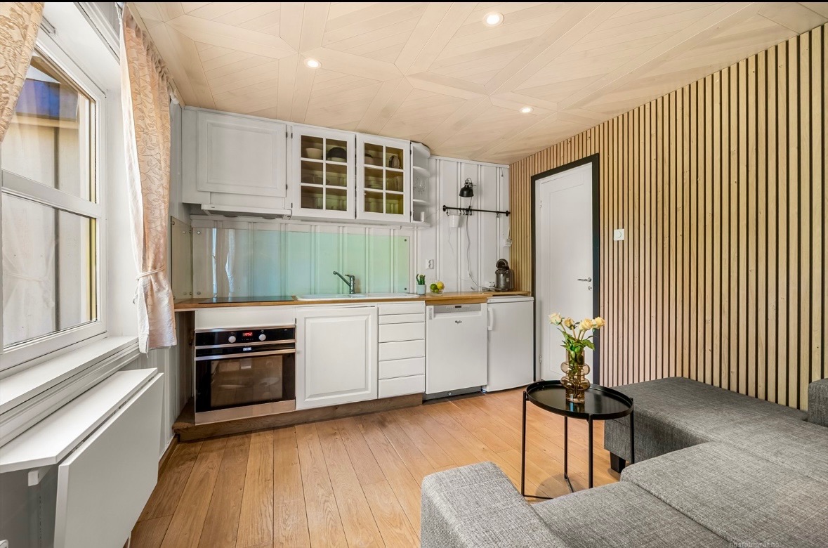 Koselig stue og kjøkken med praktisk spisebord