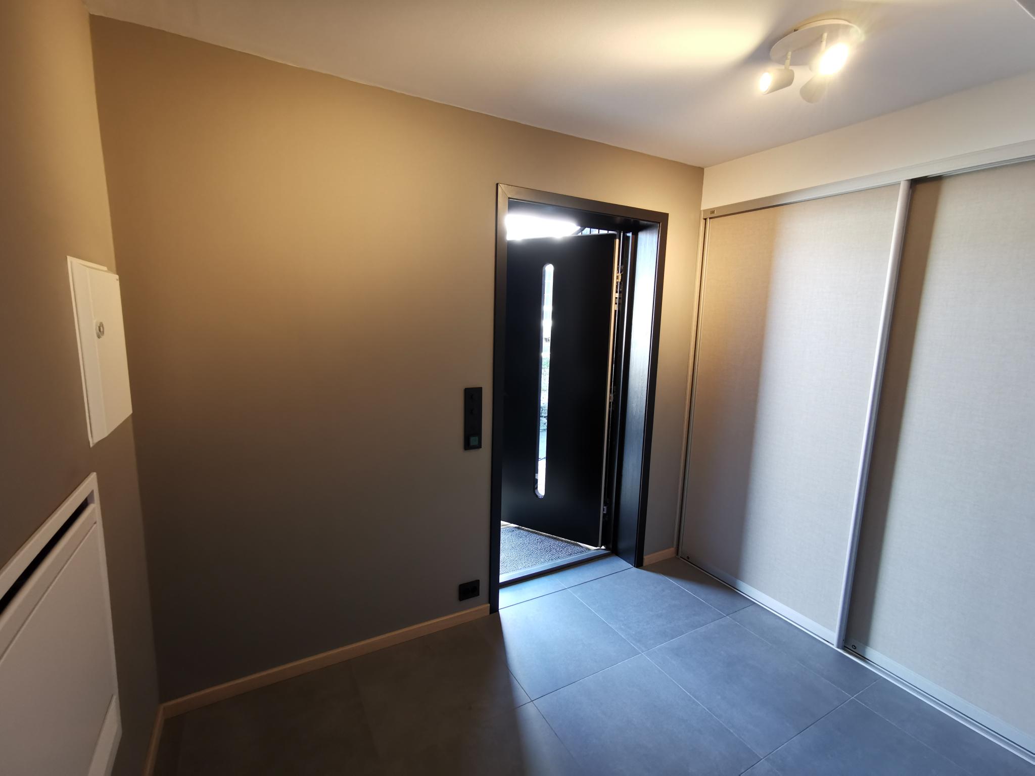 Entre sett fra kjøkken mot inngangsdør. Skyvedørsgarderobe på veggen til høyre.