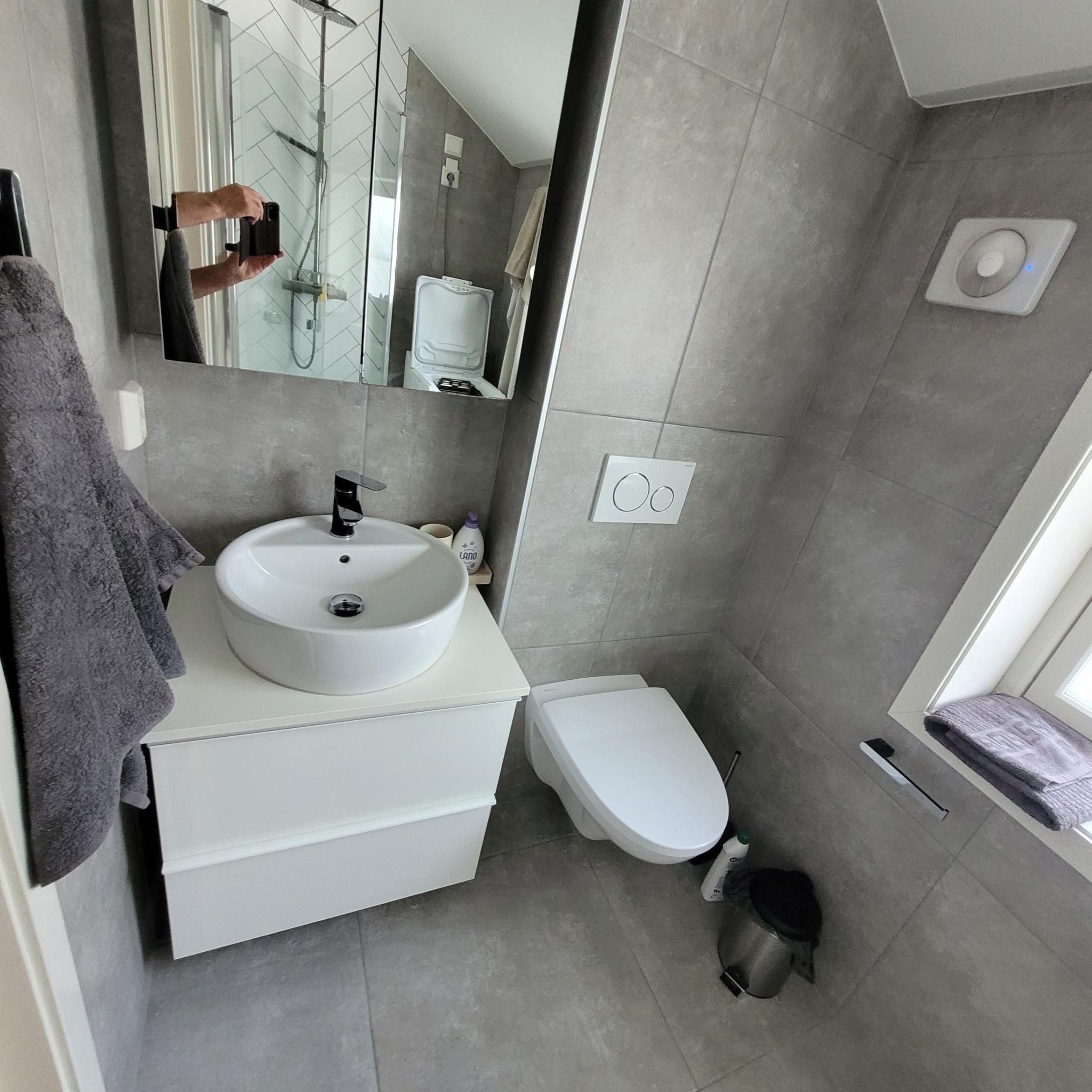 Bedet har overskap, servant med underskap og toilett