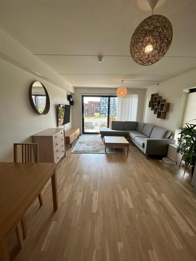 Lys stue med sollrik balkong