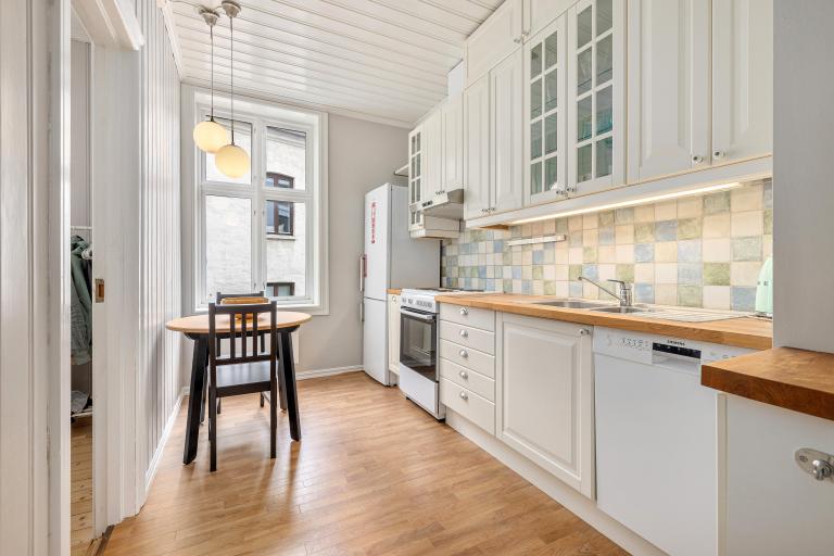 Koselig kjøkken med plass til liten sittegruppe.